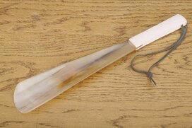 Shoe horn with leather loop and white camel bone grip ca....